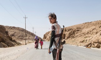 Yezidi girl carries an assault rifle to protect her family against ISIS - Adam Rifkin