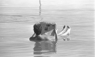 A Man Reading a Newspaper - Government Press Office