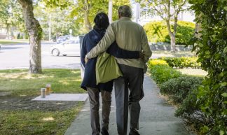 Elderly couple walk together - Hugo Chisholm