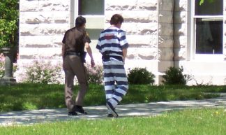 Prison inmate walking with guard - Jobs For Felons Hub